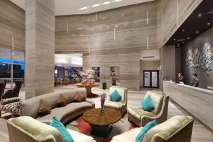 a lobby of a hotel with couches and chairs at Swiss-Belhotel Airport Jakarta in Tangerang
