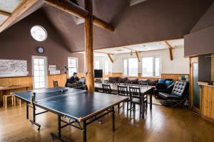 a room with a ping pong table and chairs at Absolute Niseko Lodge in Kutchan
