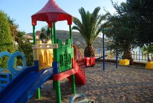 a playground with colorful play equipment in a park at Hotel Bahamas in Sarandë