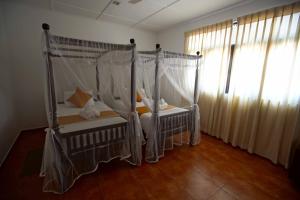 Postel nebo postele na pokoji v ubytování KapuGedara297