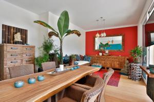 a living room with a wooden table and red walls at Landvilla Pia in Attendorf