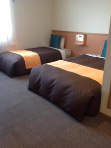 Ein Bett oder Betten in einem Zimmer der Unterkunft Hotel 1-2-3 Shimada