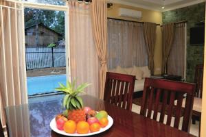 a bowl of fruit on a table in a room at Diyar Villas Puncak M3/47 in Puncak
