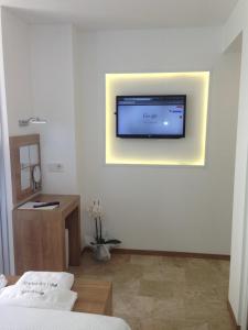 A television and/or entertainment centre at Rhapsody Hotel Kas