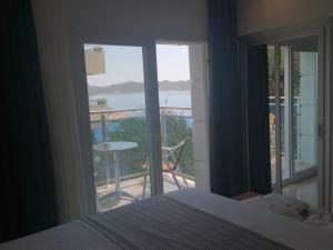 A bed or beds in a room at Rhapsody Hotel Kas