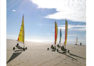 a group of sail boats on the beach at Maison Sapinettes in Quend