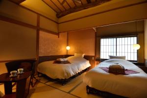 Llit o llits en una habitació de Yasaka Yutone Kyokoyado