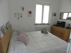 a bedroom with a bed with a dog sitting on it at Casa Sissi in Albisola Superiore