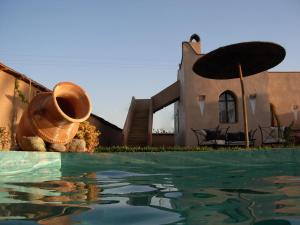 a house with a pool in front of a building at Le Jardin Des Epices in Taroudant