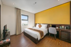Postelja oz. postelje v sobi nastanitve Cosmos Hotel Danang