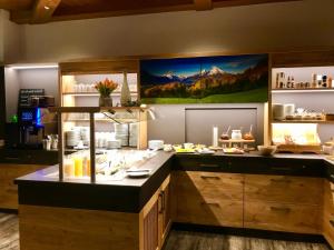a kitchen with a counter with food on it at Alpenhotel Weiherbach Berchtesgaden Hallenbad und Sauna in Berchtesgaden