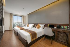Postelja oz. postelje v sobi nastanitve Cosmos Hotel Danang