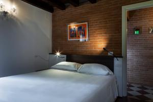 Posteľ alebo postele v izbe v ubytovaní Antico Caminetto alla Biennale