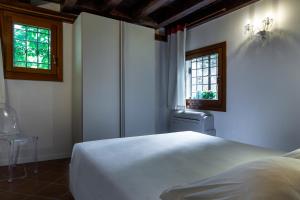 Posteľ alebo postele v izbe v ubytovaní Antico Caminetto alla Biennale