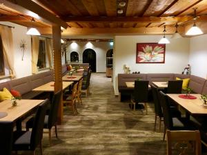 a dining room with wooden tables and chairs at Alpenhotel Weiherbach Berchtesgaden Hallenbad und Sauna in Berchtesgaden