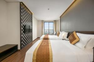 Postelja oz. postelje v sobi nastanitve Cosmos Hotel Danang