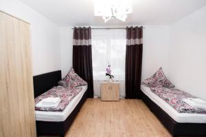 a room with two beds and a window at S-HOF Appartment in Sonnenbühl