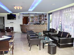 a restaurant with leather chairs and a bar at Enalion in Olympic Beach