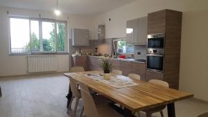 a large kitchen with a wooden table and chairs at Casa Vacanze Mercolino in Bracigliano