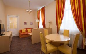 a room with a table and chairs and a living room at Oktiabrskaya Hotel in Saint Petersburg