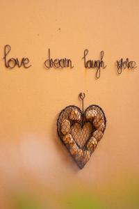 a heart on a wall with the words love dream harder at Treetops Guesthouse in Port Elizabeth