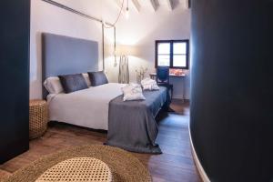 a bedroom with a bed with a table in it at Lluna Aqua Soller - Adults Recommended in Sóller