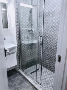 a shower with a glass door in a bathroom at New Gudauri Loft 2,apart 106 in Gudauri +13 photos
