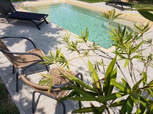 a patio with chairs and a swimming pool at Tarnóca Kúria in Soponya