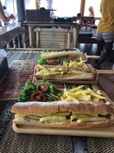 
a tray of sandwiches with french fries and pickles at Sun Beach Bungalows in Haad Rin
