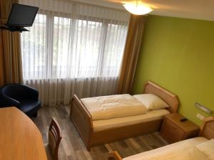 Кровать или кровати в номере RUTHMANN-Rheinblick GARNI