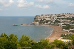 a view of a beach with buildings and the ocean at Hotel Club Village Maritalia in Peschici