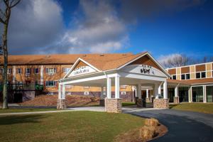 a building with a pavilion in front of a building at Carriage House Country Club in Pocono Manor