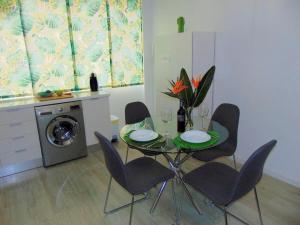 jadalnia ze stołem i krzesłami oraz pralką w obiekcie CASA PAPAGAYO w mieście Santa Cruz de Tenerife