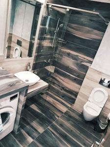 a bathroom with a toilet and a glass shower at Luxury Apartments Near to the beach in Plakias +19 photos