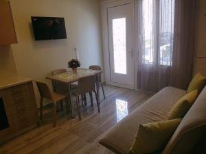 a living room with a table and a couch at Luxury Apartments Near to the beach in Plakias