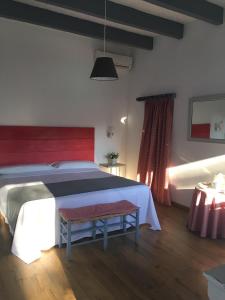 a bedroom with a large bed with a red headboard at Mesón de Sancho in Tarifa