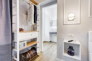 a dressing room with a closet with white cabinets at Opera Private Suites by Premium Suites Collection in Rome