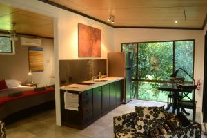 a room with a kitchen with a sink and a bed at Wongari Eco Retreat in Lamington