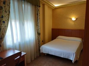 Postel nebo postele na pokoji v ubytování Hotel Real de Castilla