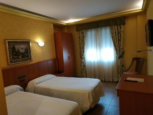 Postel nebo postele na pokoji v ubytování Hotel Real de Castilla