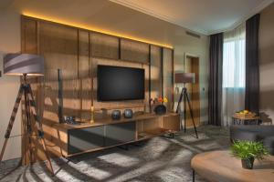 a living room with a television on a wall at Expo Hotel Sofia - Free Airport Shuttle in Sofia
