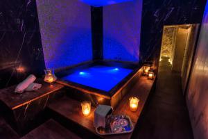a jacuzzi tub in a room with lights and candles at Ingrami Suites and Spa in Rome