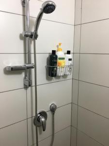 a shower with a shower head in a bathroom at Hassan Guesthouse in Nazareth +36 photos