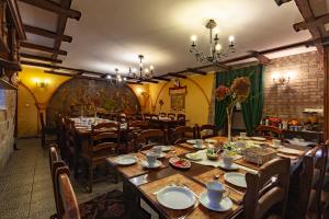 a dining room with wooden tables and chairs at Poziomka in Kujan