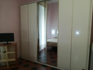 a bedroom with a mirrored closet with a bed in it at Come D'Incanto A Napoli in Naples
