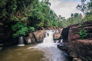 a waterfall in the middle of a river at Shinta Mani Wild- A Bensley Collection in Kampong Seila