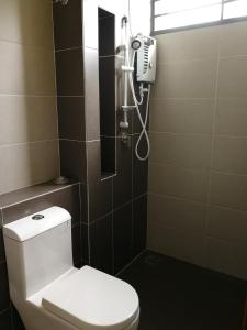 a bathroom with a white toilet and a shower at Desaru Arcadia Semi D Rooms Rental Available in Desaru