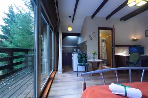 a room with a bed and a balcony at Poziomka in Kujan