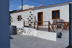 a white house with a staircase and a patio at Casa Rural alto prado in Isora