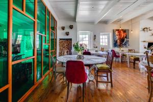 a dining room with a table and chairs at The Post House Hotel - no children under the age of 16yrs in Greyton